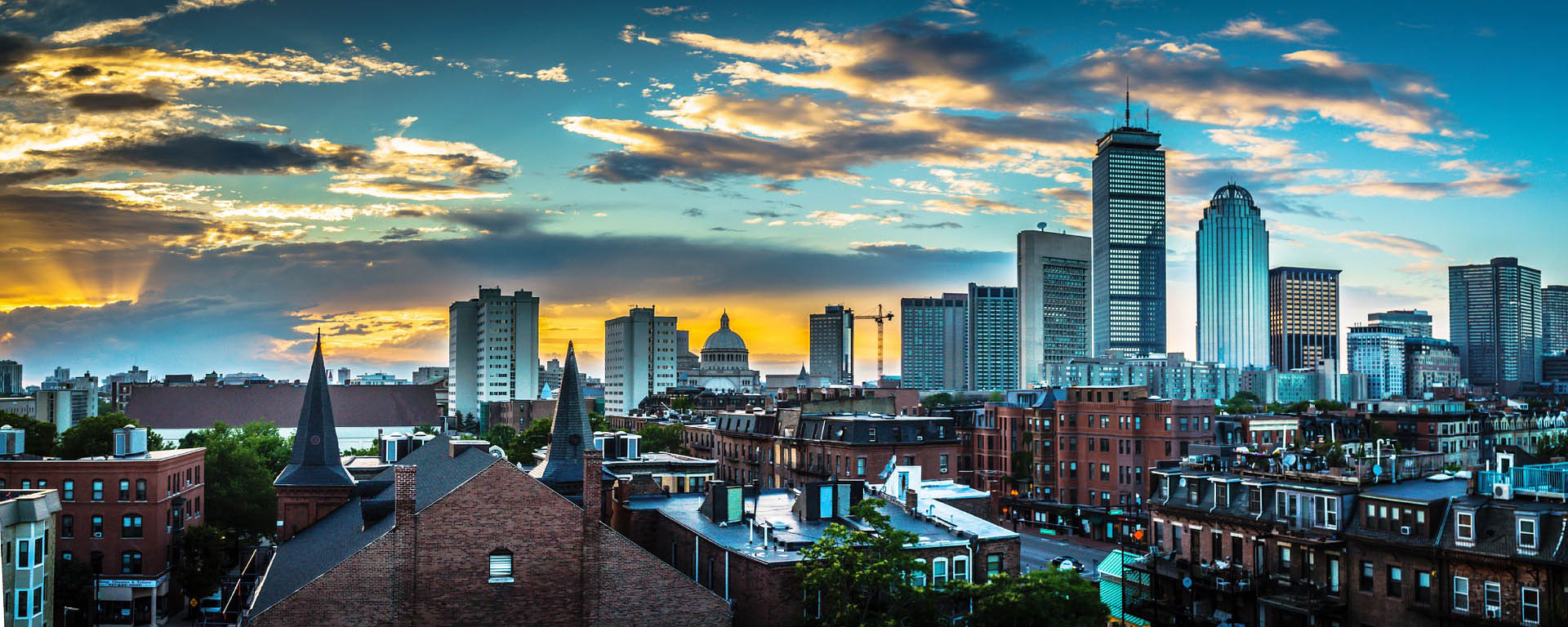A glorious photo of the Boston skyline at sunset.