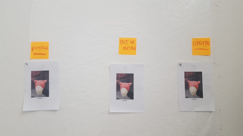 Photos of the so-called pussyhat on a wall. 